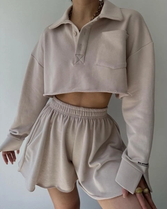 Close-up of beige long sleeve polo crop top and matching drawstring shorts set