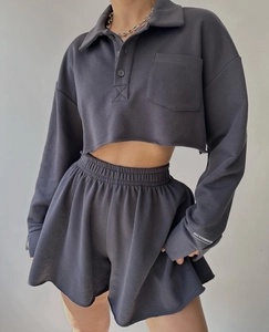 Detail of charcoal grey cropped polo sweatshirt and drawstring shorts loungewear set