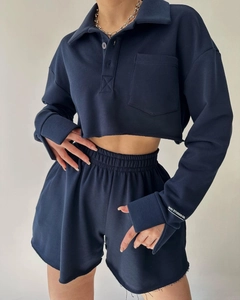 Detail of navy cropped long-sleeved top and matching drawstring shorts with raw hems