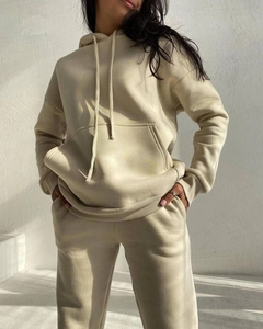 Detail showing the thick ribbed cuffs and soft fleece fabric of the cream tracksuit