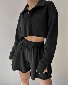 Detail of black lounge set showing raw hem cropped sweatshirt and drawstring shorts