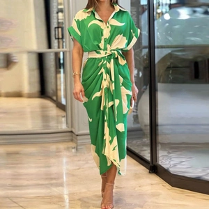 Detail of green and white floral shirt dress with lapel collar and waist tie belt