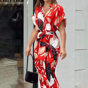 Detail view of red and white floral print maxi dress with deep V-neck and belted waistline