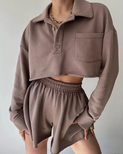 Detailed close-up of brown knit loungewear set featuring raw hem and polo collar