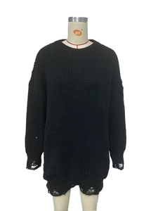 Close-up of black chunky knit sweater featuring vintage distressed ripped hole details