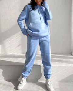 Detail of light blue fleece hoodie and joggers set featuring kangaroo pocket and ribbed cuffs