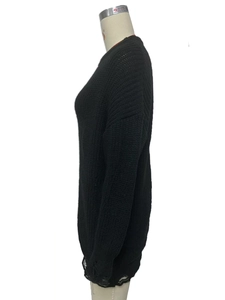 Detail view of the black chunky knit sweater featuring distressed hem and ripped design