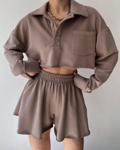Detail of crop long sleeve polo sweatshirt and matching high waist drawstring shorts