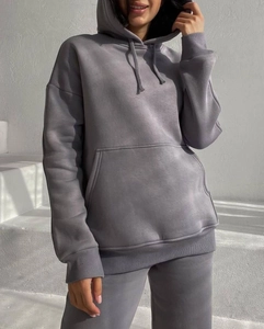 Detailed close-up of dark grey hooded tracksuit with drawstring and kangaroo pocket detail