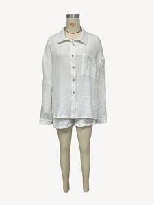 Close-up of white textured crinkle fabric on long sleeve shirt and drawstring shorts set