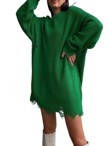 Detailed close-up showing the distressed ripped texture on green oversized knit sweater cuffs