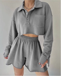 Close-up detail of grey long-sleeved polo crop top and matching shorts loungewear set