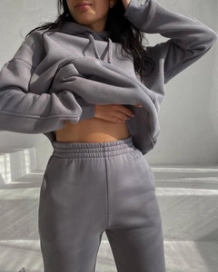 Close-up detail of dark grey fleece hoodie and matching pants with ribbed cuffs