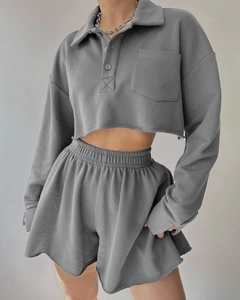 Detail of grey cropped long-sleeve sweatshirt with lapel collar and matching high-waist shorts