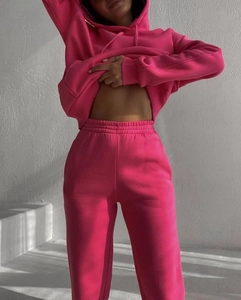 Detail of rose pink fleece hoodie and jogger set showing texture and relaxed fit