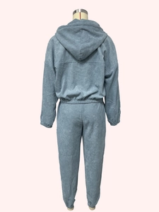 Detail view of the back of a light blue corduroy tracksuit with hooded top and elastic waist