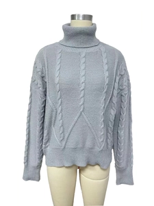 Close-up of grey cable knit texture and turtleneck detail on a casual winter sweater