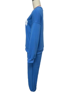 Detail of navy fleece set featuring white text print on sleeves and ribbed cuffs