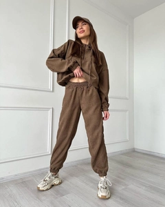 Detail view of coffee corduroy tracksuit showing ribbed texture and hooded design
