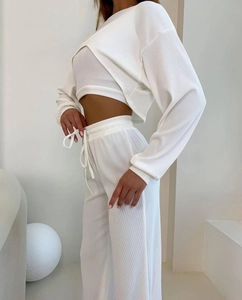 Détail du tissu côtelé blanc de l'ensemble trois pièces montrant la coupe premium