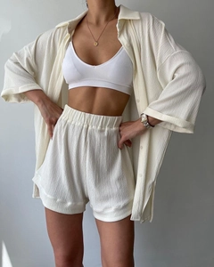 Detail shot of cream white loungewear set featuring ribbed crop top and textured fabric