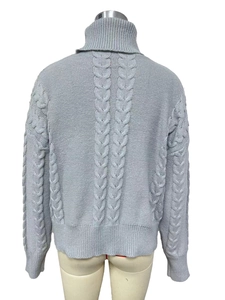 Close-up of the light blue cable knit pattern on the back of the turtleneck sweater