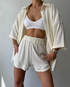 Detailed view of women's cream three-piece loungewear set with waffle texture fabric