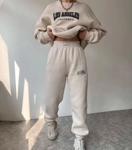 Close-up detail of Los Angeles printed tracksuit with warm natural lighting effect