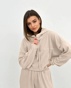 Macro detail of beige corduroy fabric texture on hoodie and joggers set