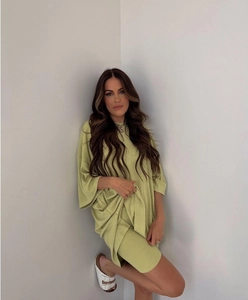 Detail of light green two-piece set featuring oversized T-shirt and high-waist cycling shorts
