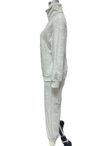Side view of a heather grey two-piece tracksuit featuring a half-zip sweatshirt and joggers