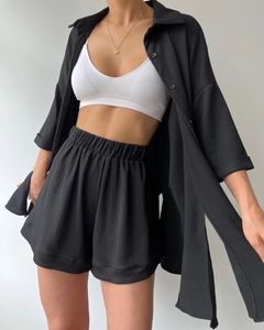 Detail shot of black two-piece set showing the unique crinkle texture fabric and high waist