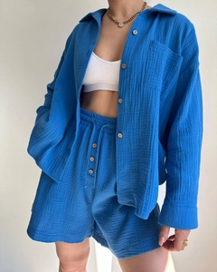 Detailed texture of royal blue crinkle fabric long sleeve shirt and matching shorts
