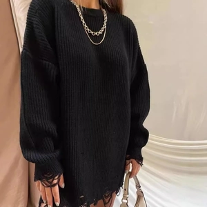 Women's black oversized knit sweater dress with ripped edges and distressed crew neck design