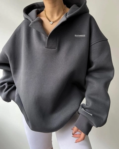 Détail d'un sweat à capuche gris avec logo MAI STUDIOS CO blanc imprimé sur la poitrine