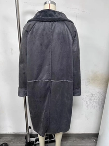 Detail view of the back seams and plush faux fur trim on a dark grey suede coat