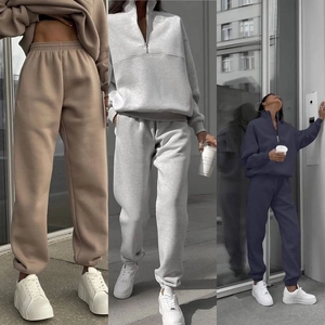 Detail of half-zip thick cotton sweatshirt and jogger pants in three neutral colors