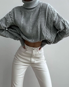 Close-up of gray cable knit turtleneck sweater texture and elegant knitwear pattern