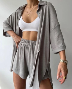 Detail shot of the crinkled fabric texture on gray casual shirt and shorts set