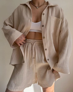 Detailed texture of beige crinkle fabric shirt and high waist drawstring shorts set