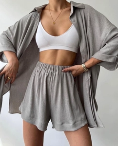 Detail of grey crinkle texture three-piece set with oversized shirt and high waist shorts