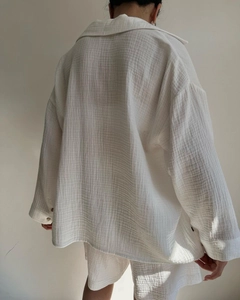 Detail shot of crinkled gauze fabric texture on cream long sleeve shirt set