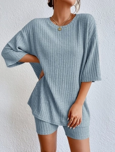 Detailed close-up showing the vertical ribbed knit texture of a blue short sleeve set