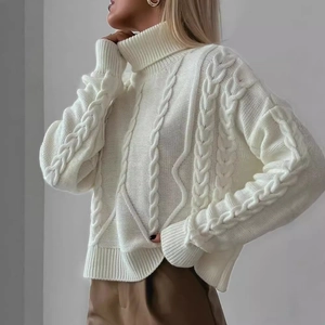 Women's white cable knit turtleneck sweater with chunky textured weave and loose fit
