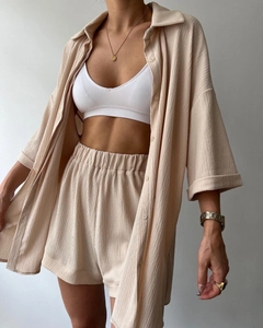 Detail of apricot two-piece textured set with split-sleeve shirt and elastic waist shorts