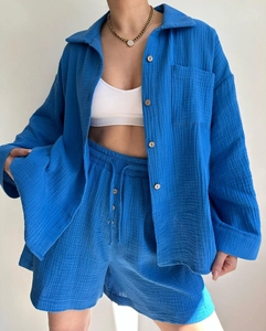 Detail of royal blue crinkle fabric shirt and high-waist drawstring shorts set for women