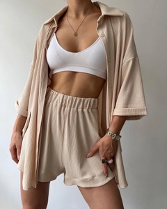 Detail of beige textured fabric on high-waist shorts and loose open-front shirt set