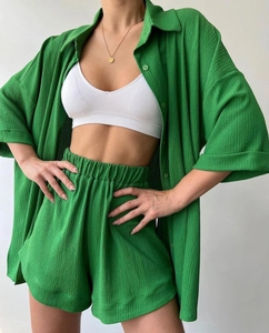 Detailed macro view of the grass green pleated texture fabric on this casual summer set