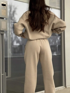 Full back view of a beige knitted tracksuit featuring a loose hoodie and matching pants