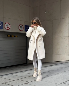 Detail of white shearling long coat with lapel collar and warm fleece lining